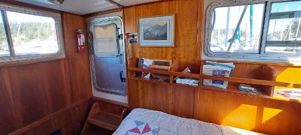 Slide: The Image of Cozy cabin interior of 1999 Rozema Boat Works Custom 42 with wooden paneling and natural light. - 23