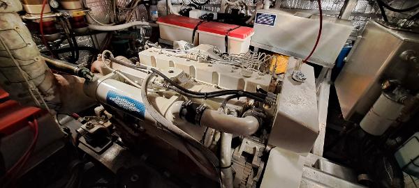 Slide: The Image of Engine room of a 1999 Rozema Boat Works Custom 42, showcasing mechanical components. - 27