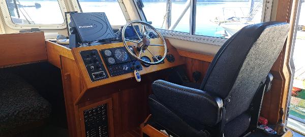 Slide: The Image of 1999 Rozema Boat Works Custom 42 helm station with steering wheel and navigation equipment. - 6
