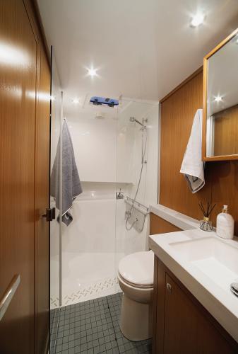 Slide: The Image of Modern bathroom in 2023 Sargo 45 boat with shower, sink, and wooden accents. - 11