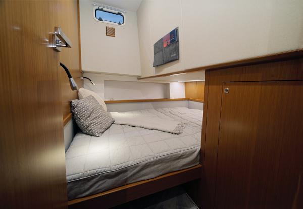 Slide: The Image of Cozy cabin interior of 2023 Sargo 45 boat with wooden finish and comfortable bedding. - 12