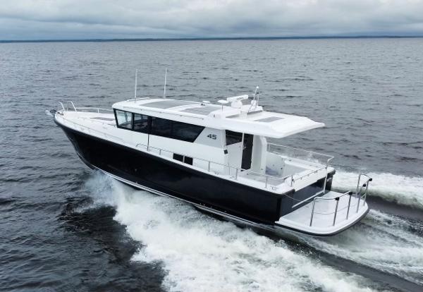 Slide: The Image of 2023 Sargo 45 boat cruising on open water under cloudy skies. - 17