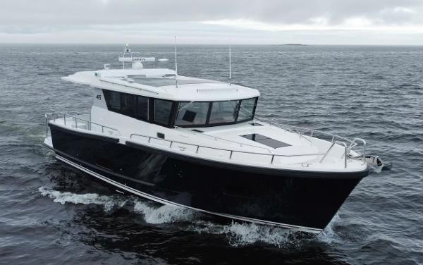 Slide: The Image of 2023 Sargo 45 boat cruising on open water under cloudy skies. - 18