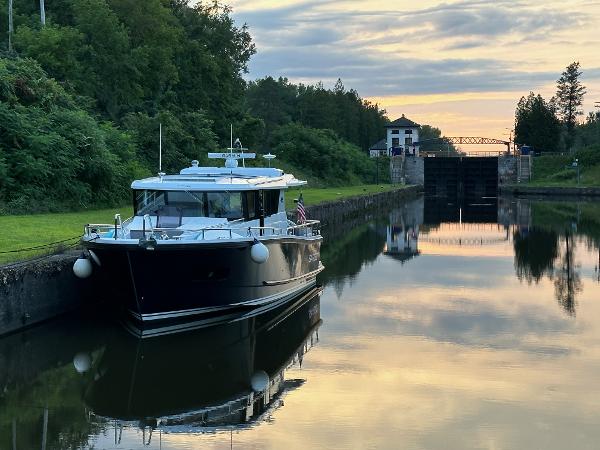 Slide: The Image of Sargo 45 boat docked in a serene canal at sunset, 2023 model. - 21