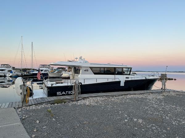 Slide: The Image of 2023 Sargo 45 yacht docked at a marina during sunset. - 25