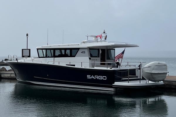 Slide: The Image of 2023 Sargo 45 boat docked at a marina. - 28