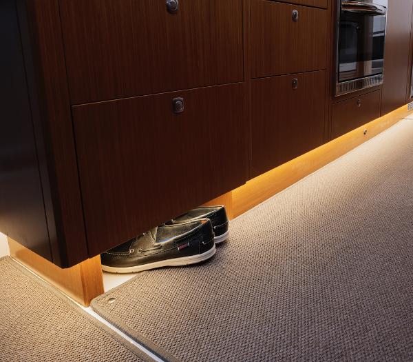 Slide: The Image of Interior of 2023 Sargo 45 boat with under-cabinet lighting and carpeted flooring. - 8