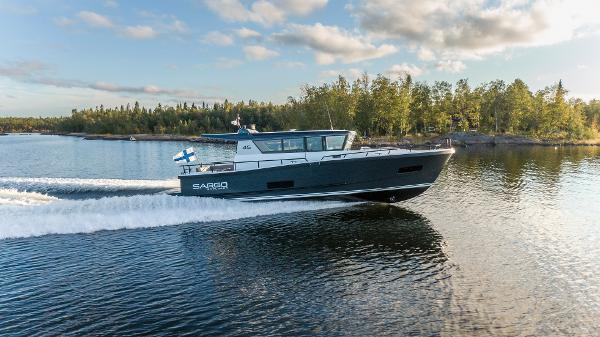 Slide: The Image of 2025 Sargo 45 Cat A boat cruising on a serene lake. - 2