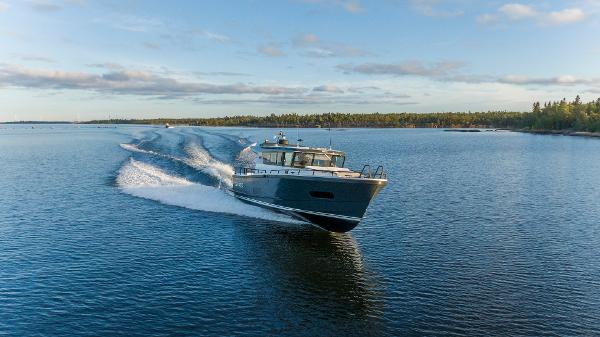 Slide: The Image of Sargo 45 Cat A 2025 motorboat cruising on a serene lake. - 5