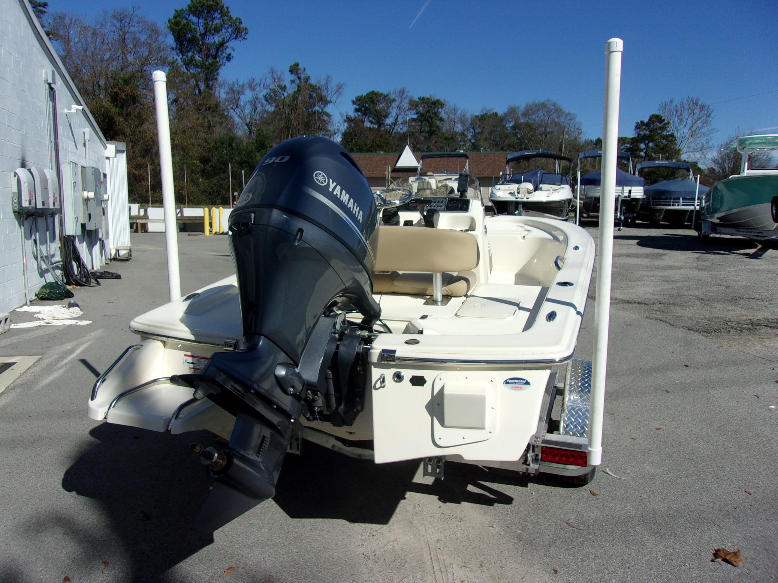 Slide: The Image of 2024 Scout 177 Sport boat with Yamaha outboard motor in a marina. - 3