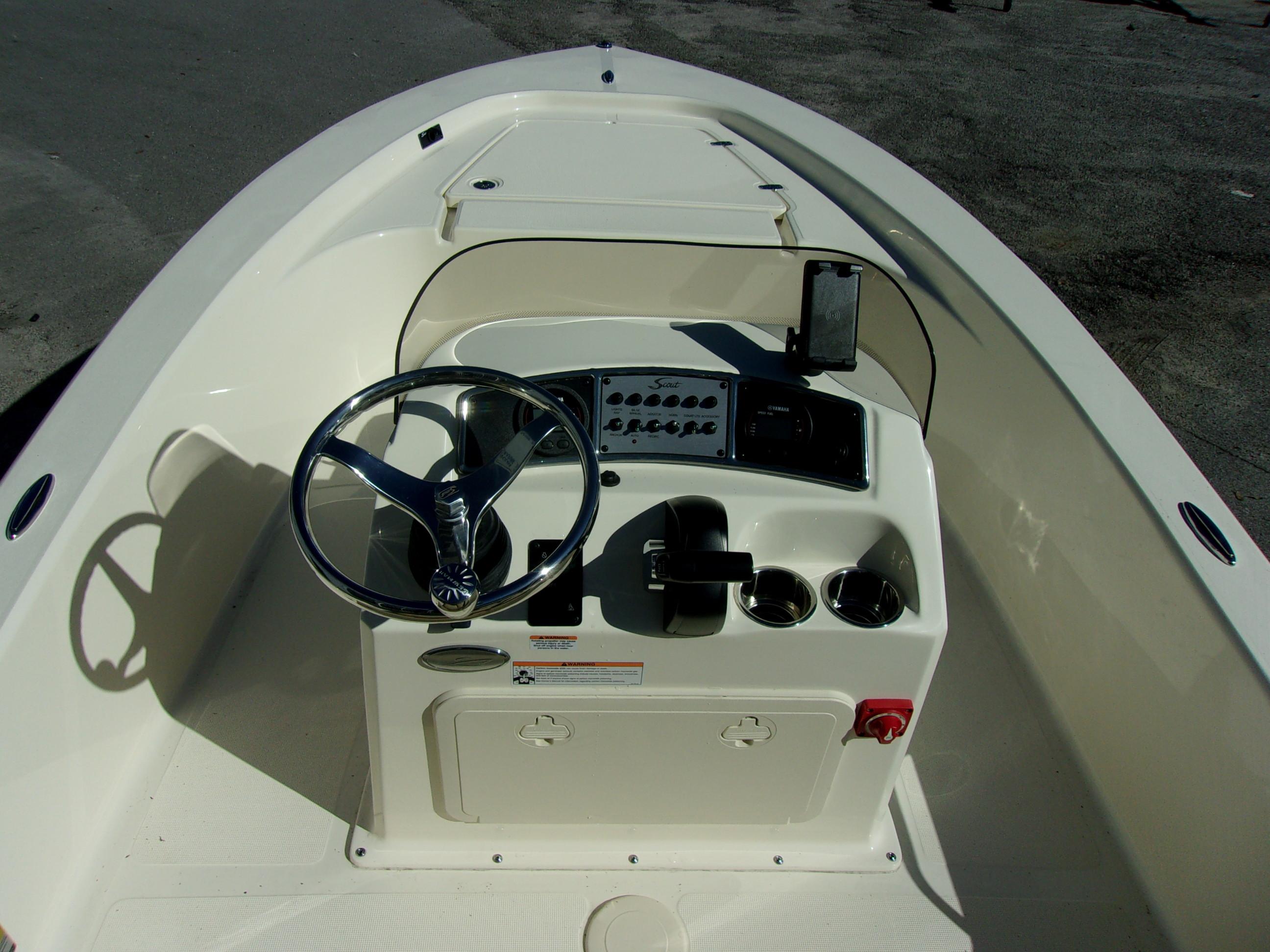 Slide: The Image of 2024 Scout 177 Sport boat console with steering wheel and controls. - 8