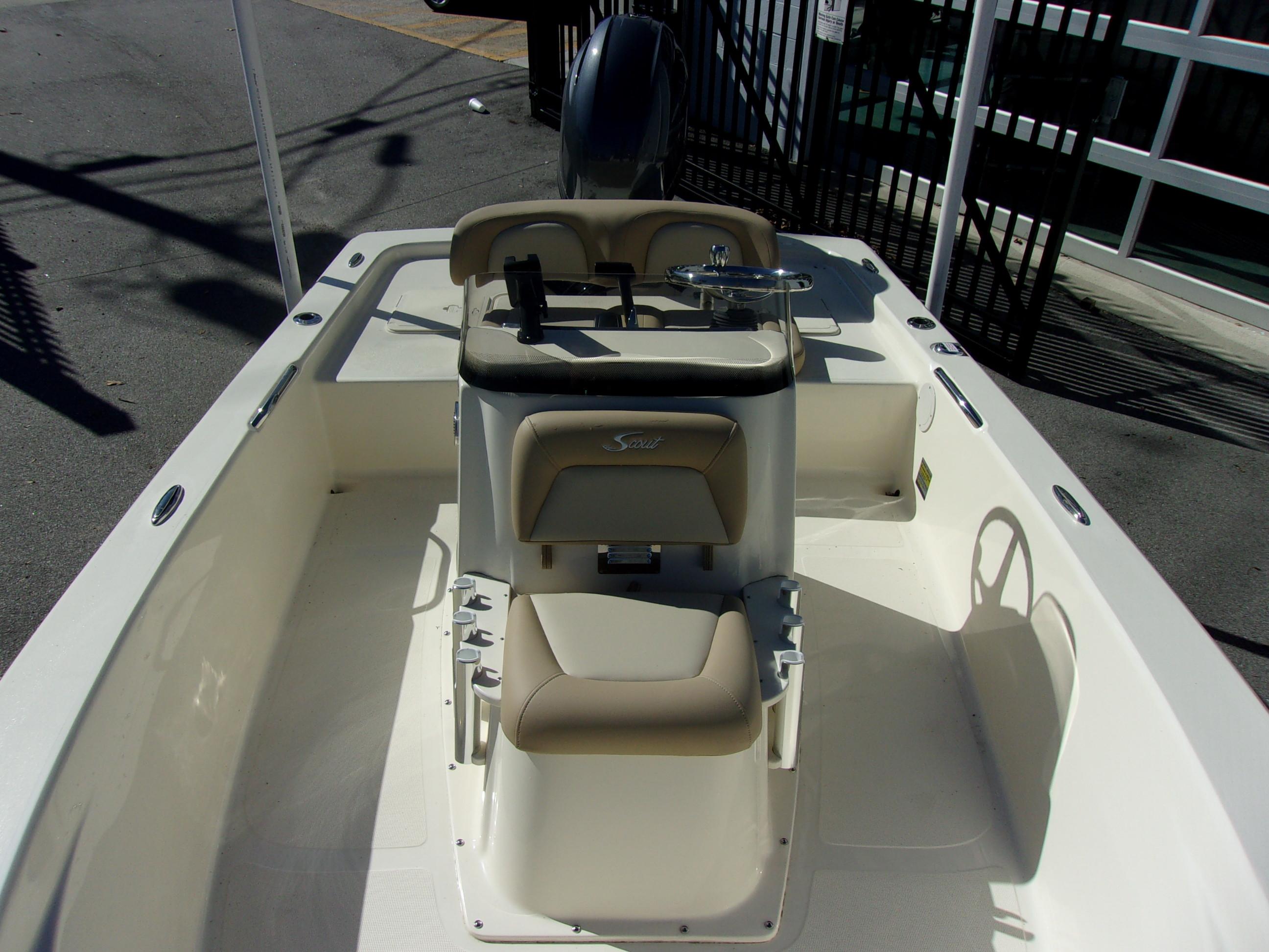 Slide: The Image of 2024 Scout 177 Sport boat interior with beige seating and steering console. - 9
