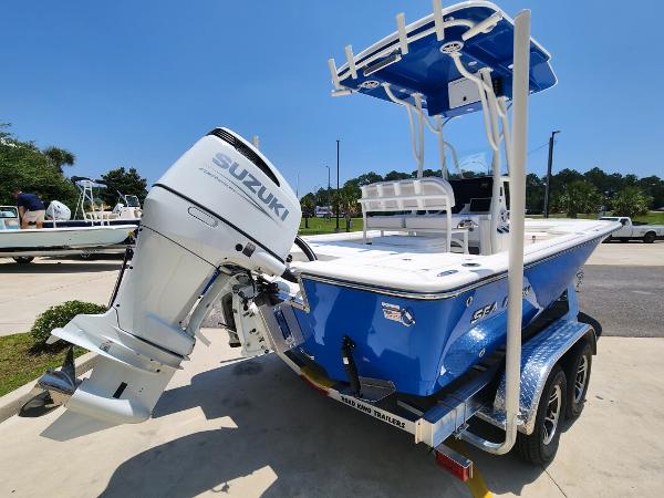 Slide: The Image of 2023 Sea Born FX22 Bay boat with Suzuki outboard motor on trailer. - 1