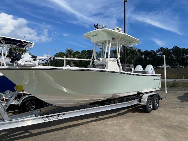 Slide: The Image of 2024 Sea Born LX 24 LE boat on a trailer under a clear blue sky. - 1