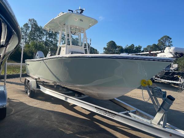 Slide: The Image of 2024 Sea Born LX 24 LE boat on a trailer in a parking lot. - 2