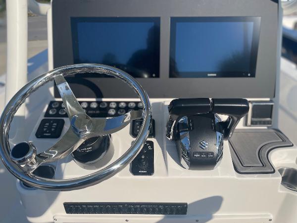 Slide: The Image of 2024 Sea Born LX 24 LE boat dashboard with dual screens and steering wheel. - 4