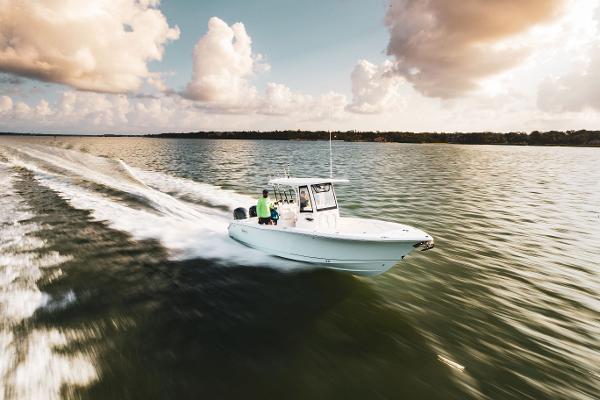 Slide: The Image of 2025 Sea Hunt Gamefish 25 speeding on open water under cloudy sky. - 3