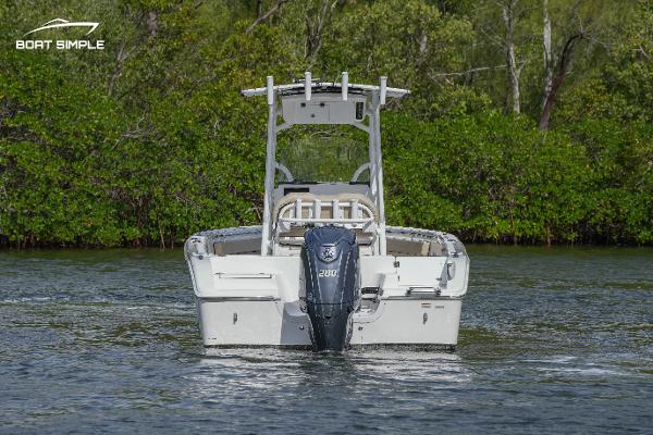 Slide: The Image of 2023 Sea Pro 219 Deep V CC boat on water, rear view. - 2