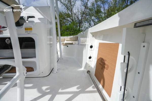 Slide: The Image of 2023 Sea Pro 219 Deep V CC boat interior with white deck and storage compartments. - 8