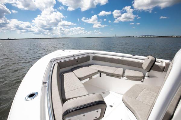 Slide: The Image of 2024 Sea Pro 222 Center Console boat with spacious seating on calm waters. - 2