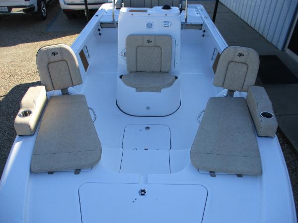 Slide: The Image of 2024 Sea Pro 228 DLX Bay boat interior with beige seating and white deck. - 14