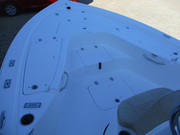 Slide: The Image of 2024 Sea Pro 228 DLX Bay boat deck with storage compartments and seating. - 15