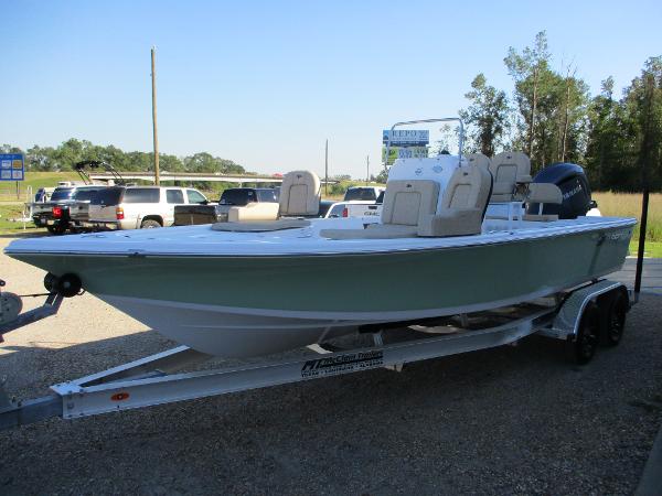 Slide: The Image of 2024 Sea Pro 228 DLX Bay boat on a trailer in a parking lot. - 2