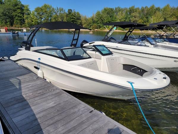 Slide: The Image of 2023 Sea Ray 230 SPX boat docked on a sunny day. - 0