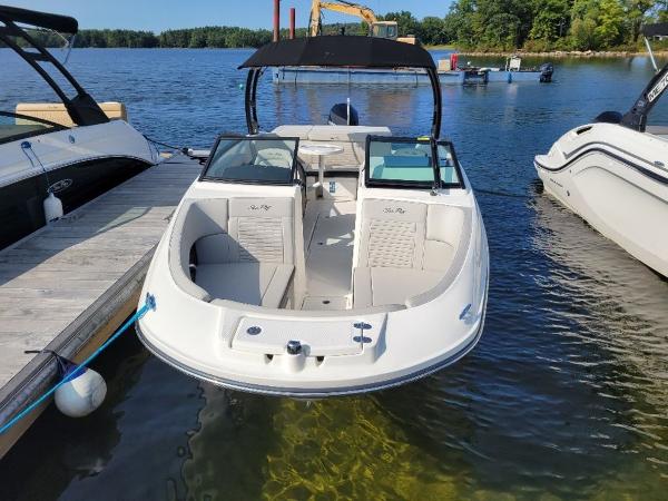 Slide: The Image of 2023 Sea Ray 230 SPX boat docked on a clear lake. - 10