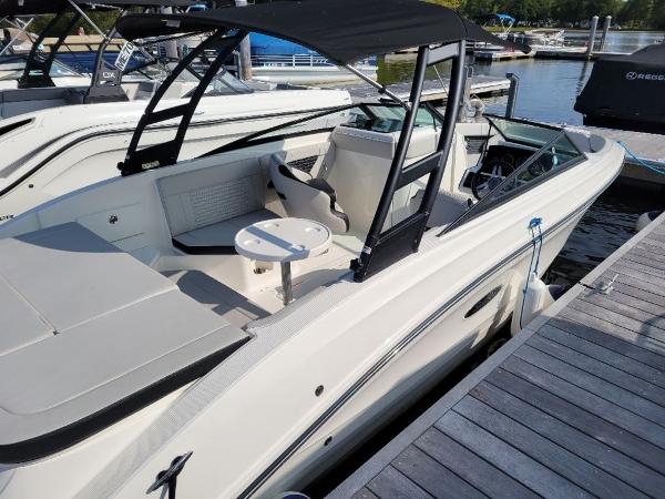 Slide: The Image of 2023 Sea Ray 230 SPX boat docked, featuring a sleek design and spacious seating. - 3