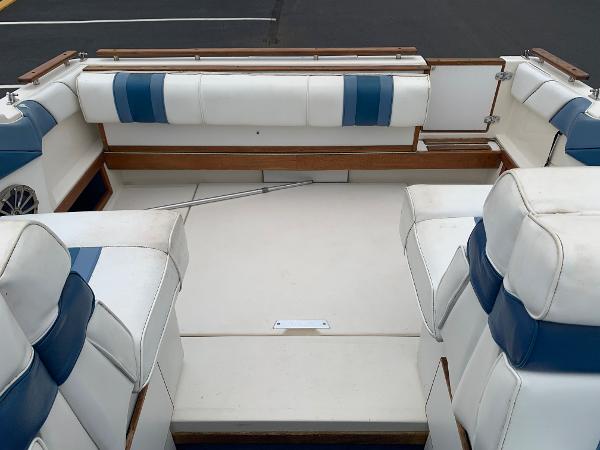 Slide: The Image of 1989 Sea Ray 230 Weekender boat interior with white and blue seating. - 8
