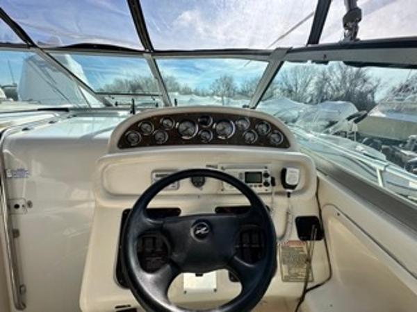 Slide: The Image of 1998 Sea Ray 290 Sundancer boat helm with steering wheel and instrument panel. - 10