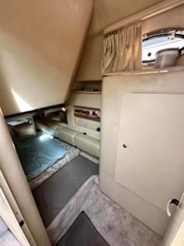Slide: The Image of Interior cabin of a 1998 Sea Ray 290 Sundancer boat with bed and storage. - 20