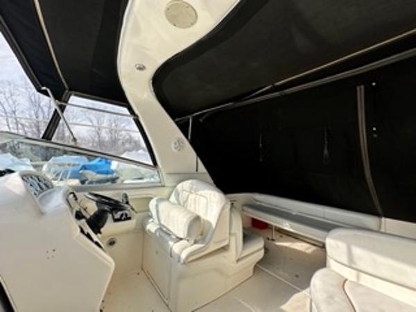Slide: The Image of 1998 Sea Ray 290 Sundancer boat interior with white seating and black canopy. - 7