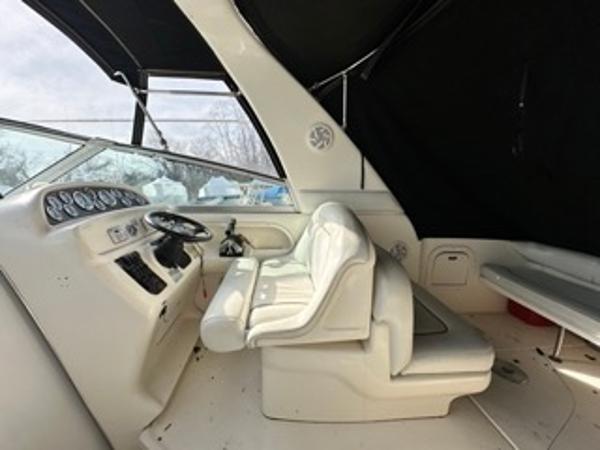 Slide: The Image of 1998 Sea Ray 290 Sundancer cockpit with white leather seats and control panel. - 8
