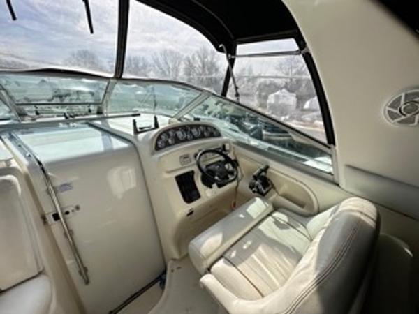 Slide: The Image of 1998 Sea Ray 290 Sundancer cockpit with steering wheel and dashboard. - 9
