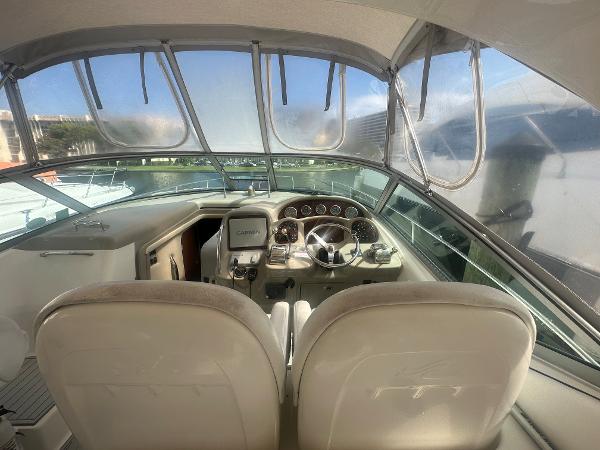Slide: The Image of 2006 Sea Ray 340 Sundancer cockpit with dual seats and modern controls. - 23