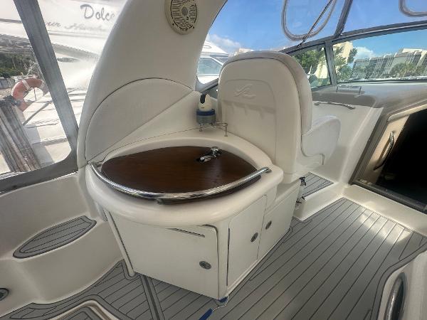 Slide: The Image of 2006 Sea Ray 340 Sundancer cockpit with seating and sink. - 32
