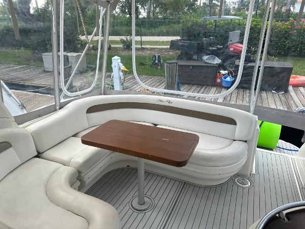 Slide: The Image of Interior seating area of a 2006 Sea Ray 340 Sundancer yacht with a wooden table. - 34