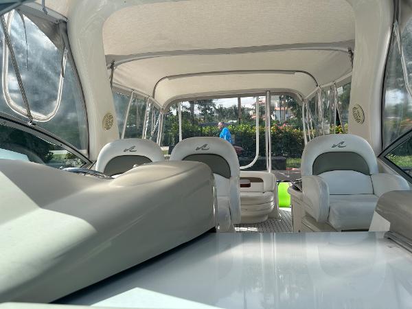 Slide: The Image of Interior of a 2006 Sea Ray 340 Sundancer boat with white seating and canopy. - 40
