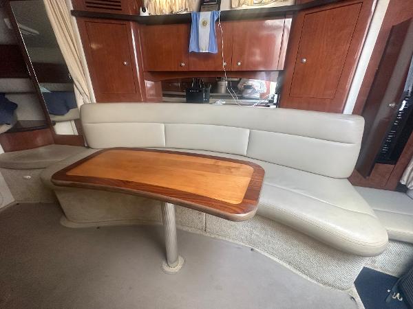 Slide: The Image of Interior of a 2006 Sea Ray 340 Sundancer with a curved sofa and wooden table. - 41