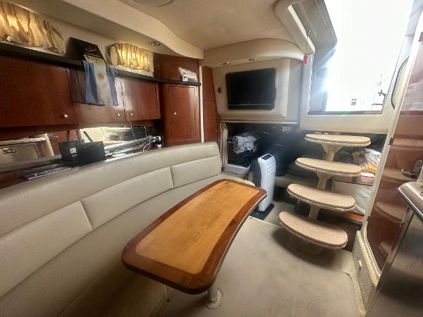 Slide: The Image of Interior of 2006 Sea Ray 340 Sundancer yacht with seating, table, and stairs. - 42