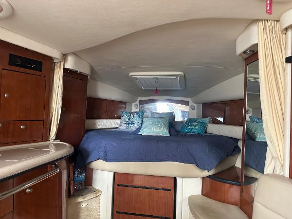 Slide: The Image of Interior cabin of a 2006 Sea Ray 340 Sundancer yacht with bed and storage. - 48