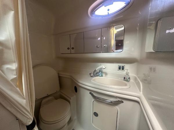 Slide: The Image of 2006 Sea Ray 340 Sundancer bathroom with sink, toilet, and storage cabinets. - 51