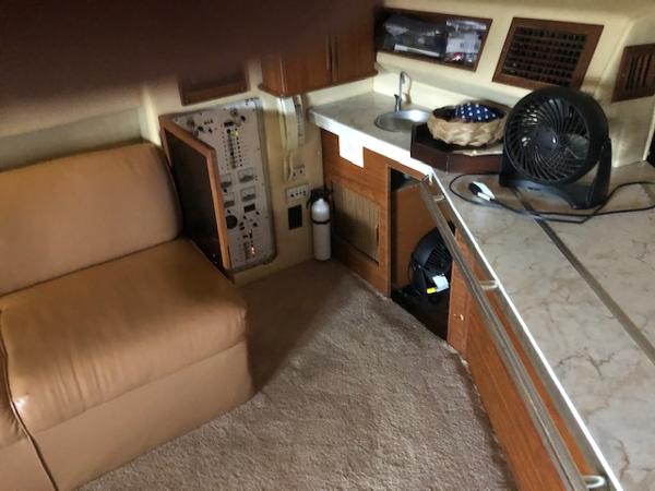 Slide: The Image of Interior of 1983 Sea Ray 390 Sport Fisherman with beige seating and kitchenette. - 19