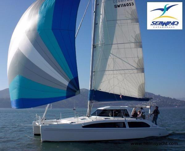 Slide: The Image of 2024 Seawind 1160 Lite catamaran sailing on a sunny day. - 0