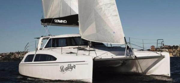 Slide: The Image of 2024 Seawind 1160 Lite catamaran sailing on open water. - 1