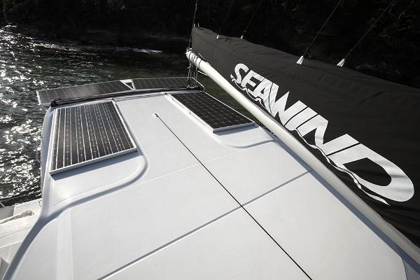 Slide: The Image of 2024 Seawind 1160 Lite catamaran with solar panels and Seawind-branded sail. - 14