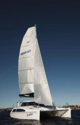 Slide: The Image of 2024 Seawind 1160 Lite catamaran sailing on open water. - 2