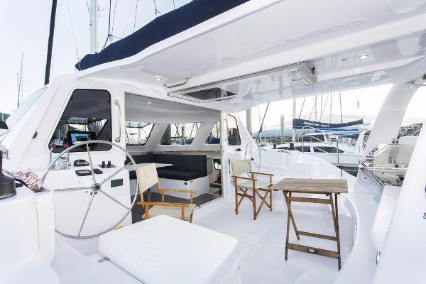 Slide: The Image of 2024 Seawind 1160 Lite yacht cockpit with seating and steering wheel. - 22